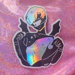 black sticker of a guy in blindfold with bat wings and holographic detail