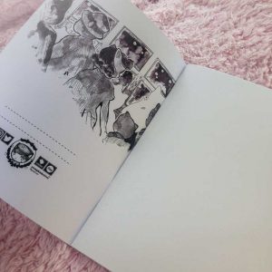 a unlines sketchbook with an illustration gakuran wearing cat traveling by train