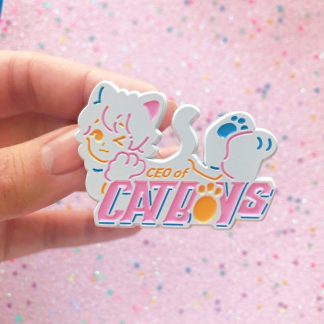 pastel colored enamel pin in a shape of a cute anime neko boy with words saying "ceo of catboys"